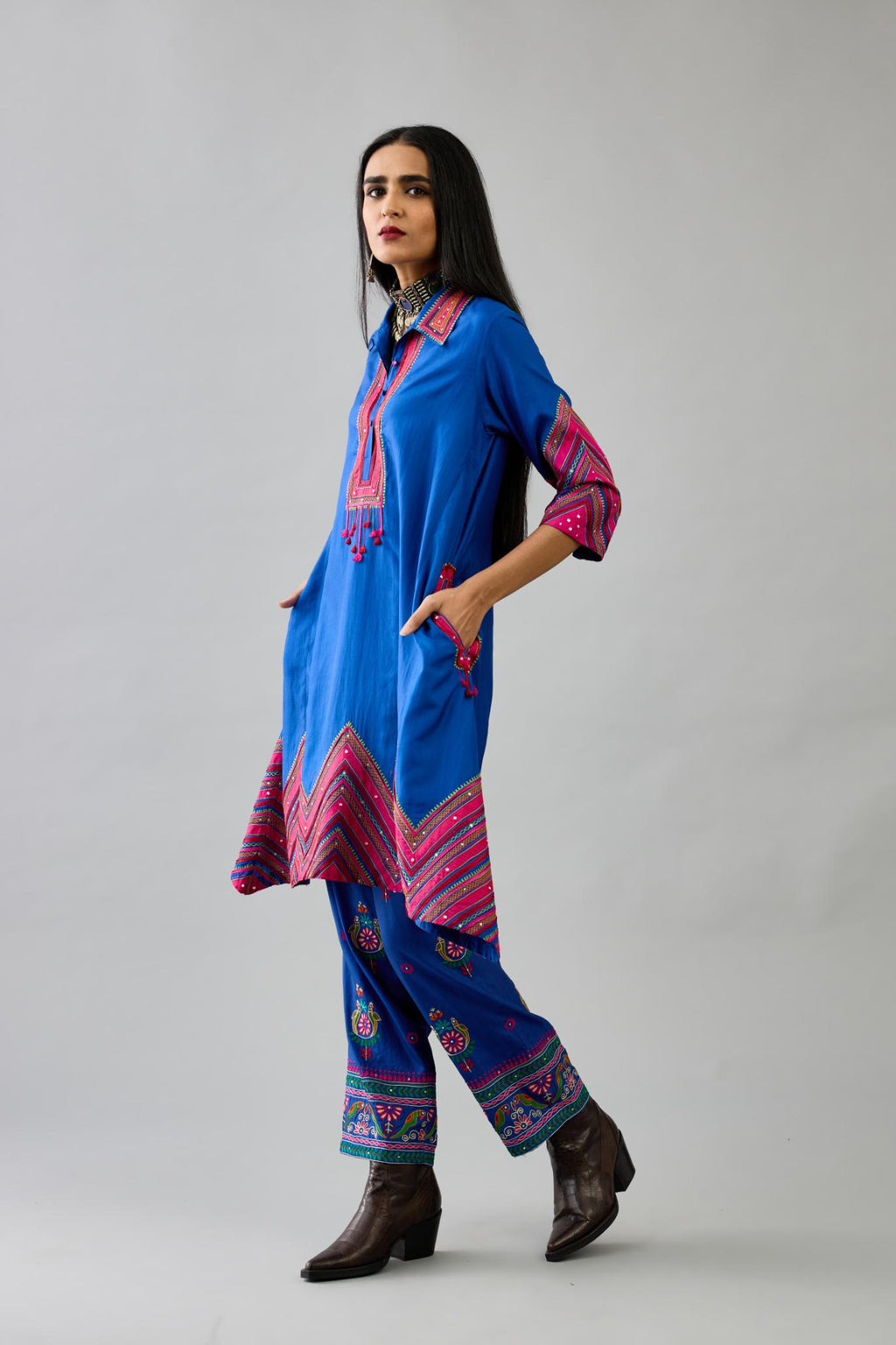 Blue Silk A-line kurta with collar, detailed with patchwork, silk thread embroidery, mirrors, sequins and tassels.