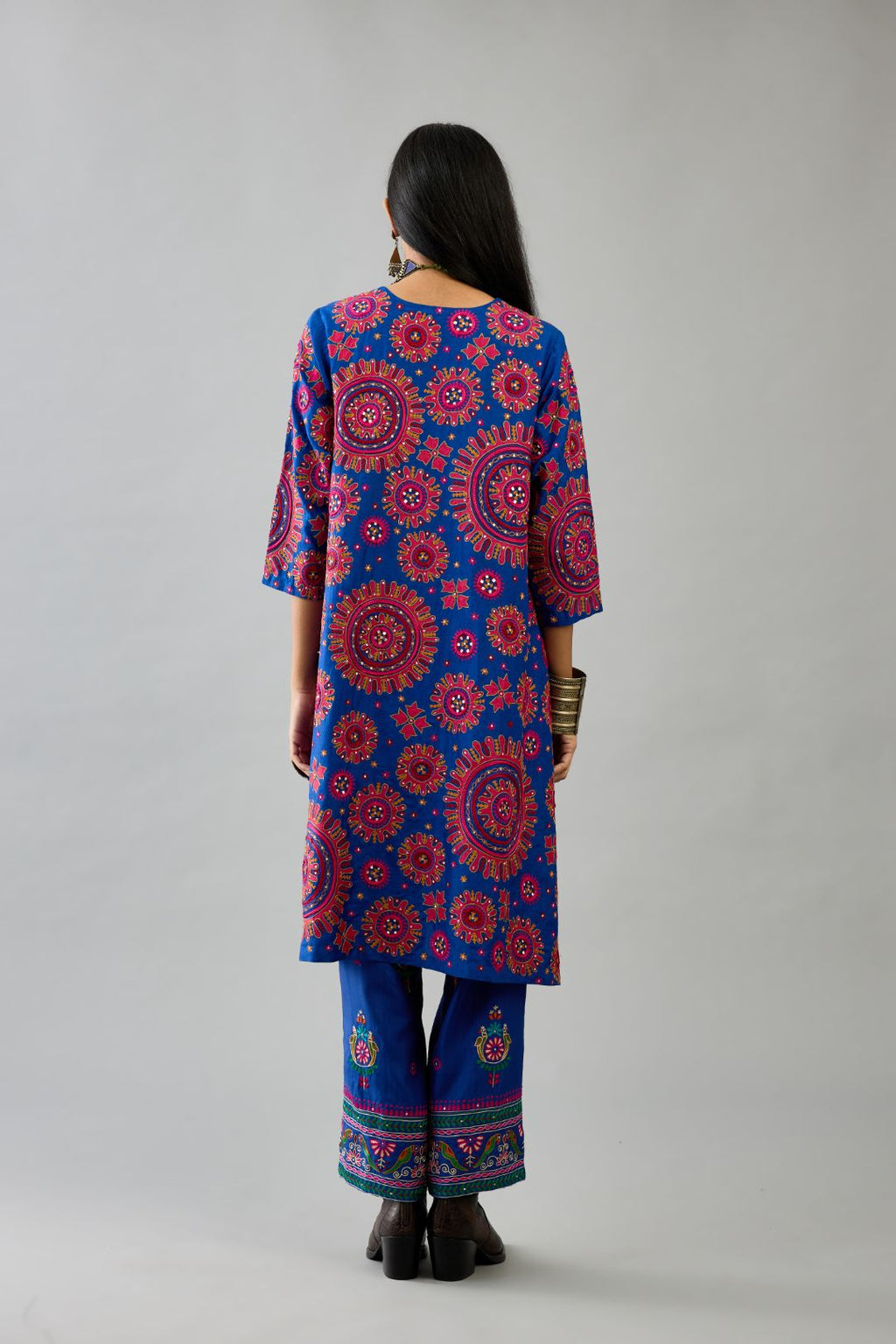 Blue A-line silk kurta set with all over patchwork, silk thread, mirror, tassels and sequin embroidery.