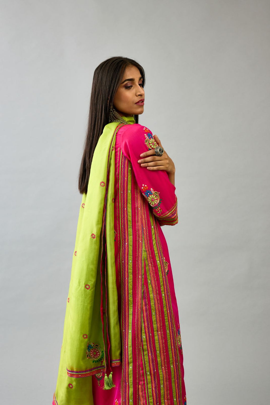 Fuchsia silk straight kurta set with yoke and side panels. It has allover patchwork and silk thread embroidery, highlighted with mirror, sequins, tassels and braids.