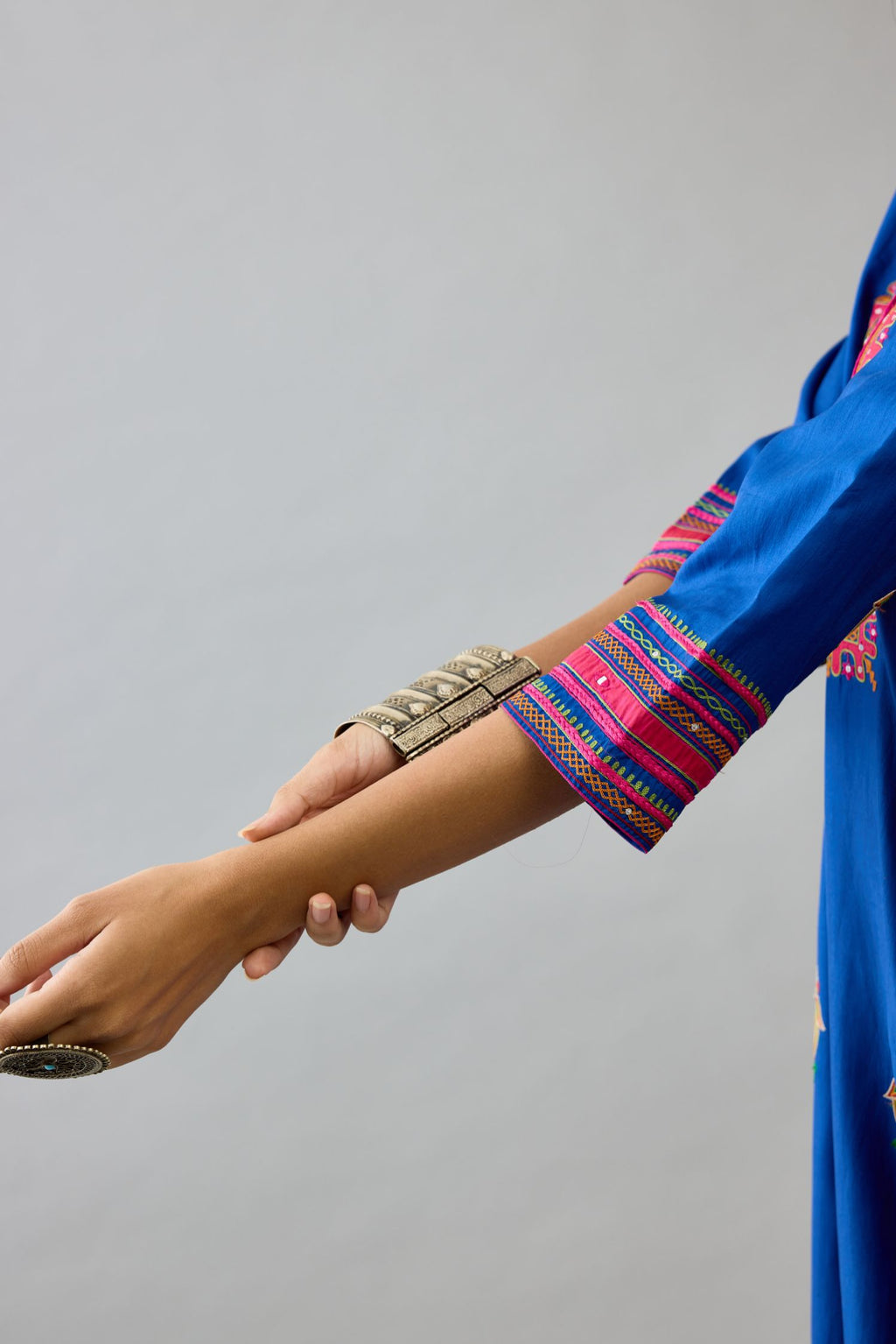 Blue silk straight kurta set with yoke and side panels. It has allover patchwork and silk thread embroidery, highlighted with mirror, sequins, tassels and braids.