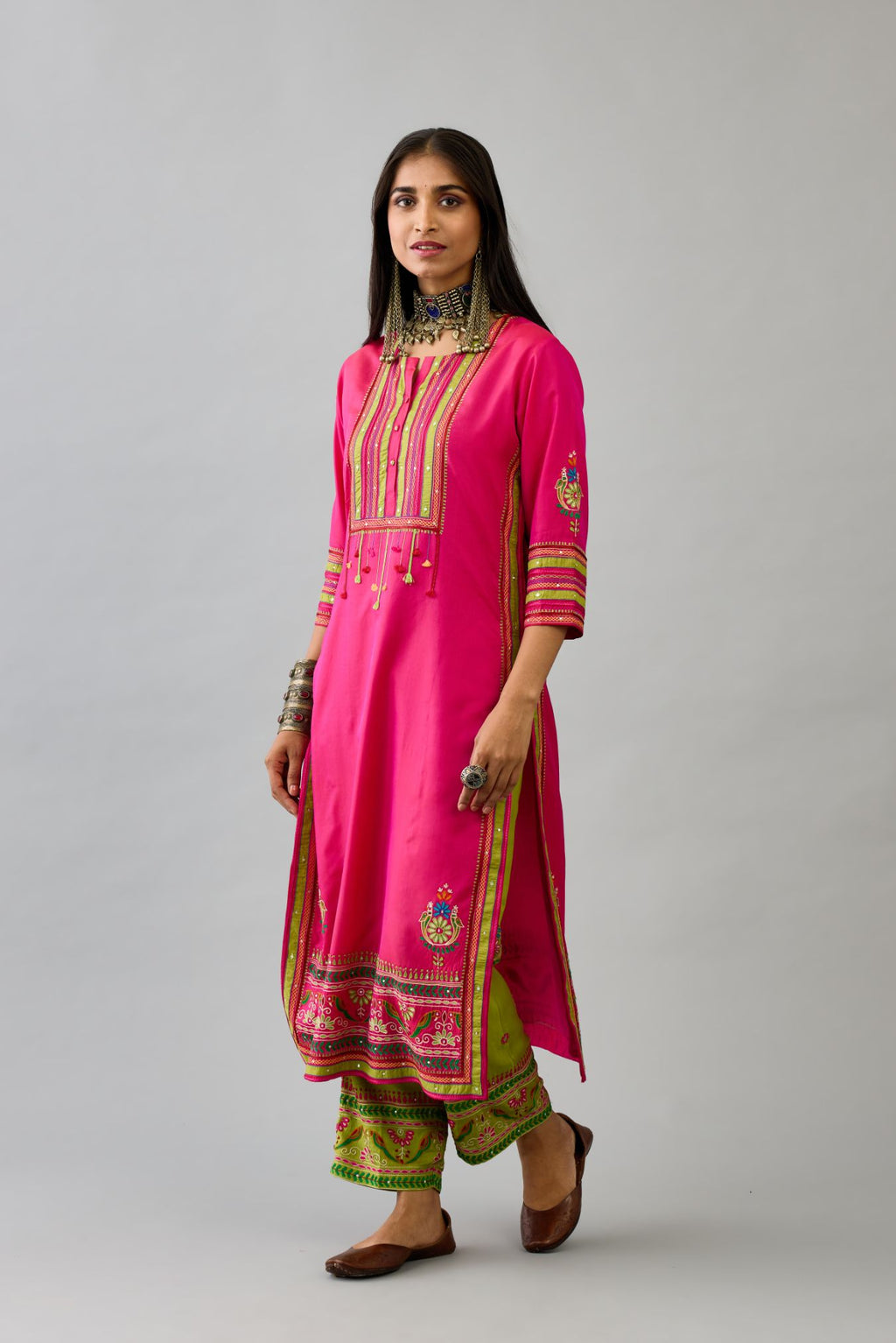 Fuchsia silk straight set kurta with yoke with patchwork and silk thread embroidery highlighted with mirror, sequins, tassels and braids.