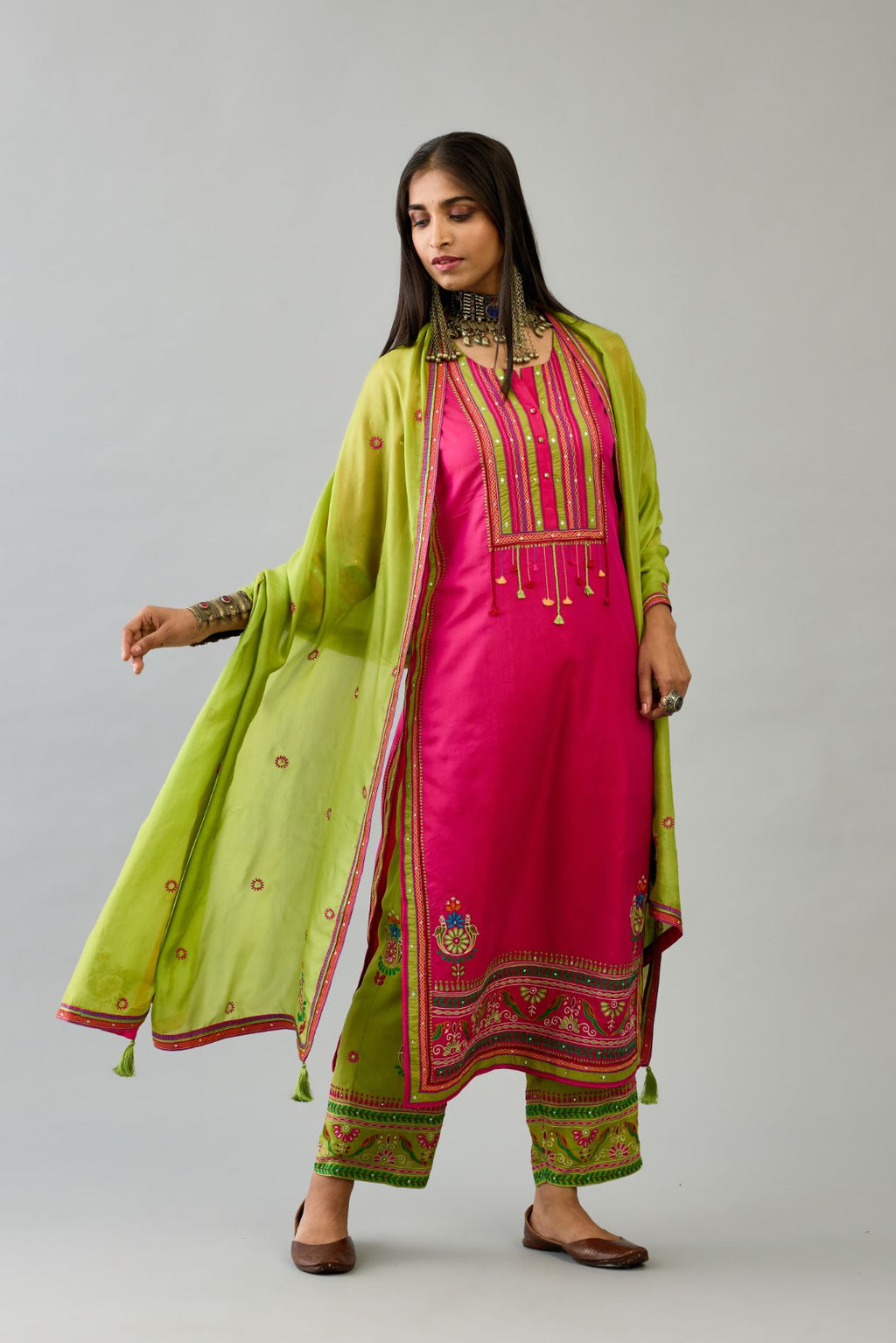 Fuchsia silk straight set kurta with yoke with patchwork and silk thread embroidery highlighted with mirror, sequins, tassels and braids.