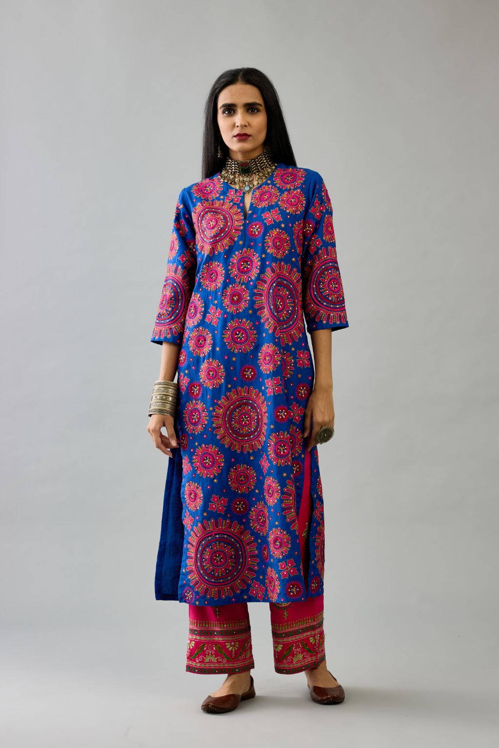 Blue silk straight kurta set with all over patchwork, silk thread, mirror, tassels and sequins embroidery.