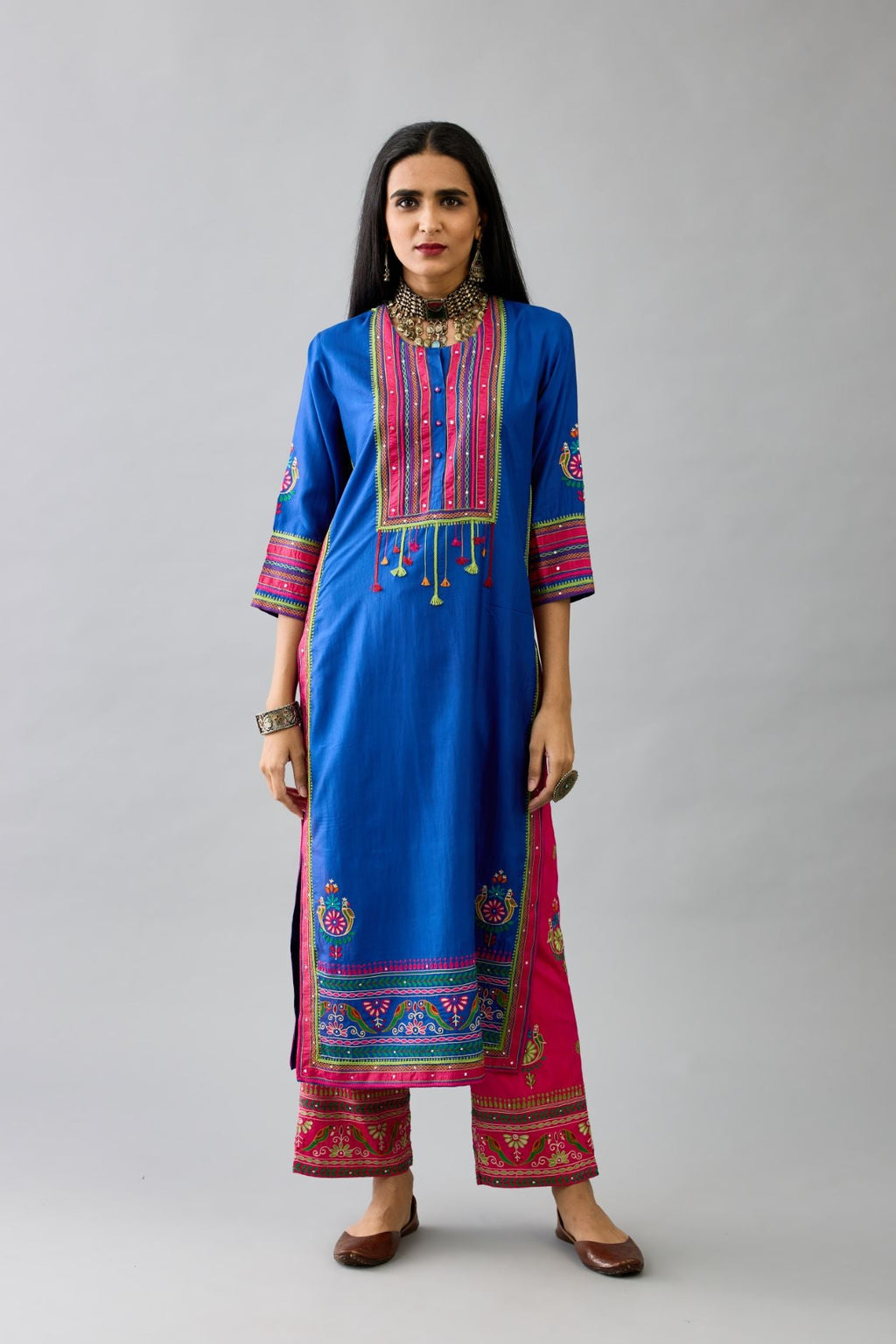 Blue silk straight kurta with yoke with patchwork and silk thread embroidery highlighted with mirror, sequins, tassels and braids.