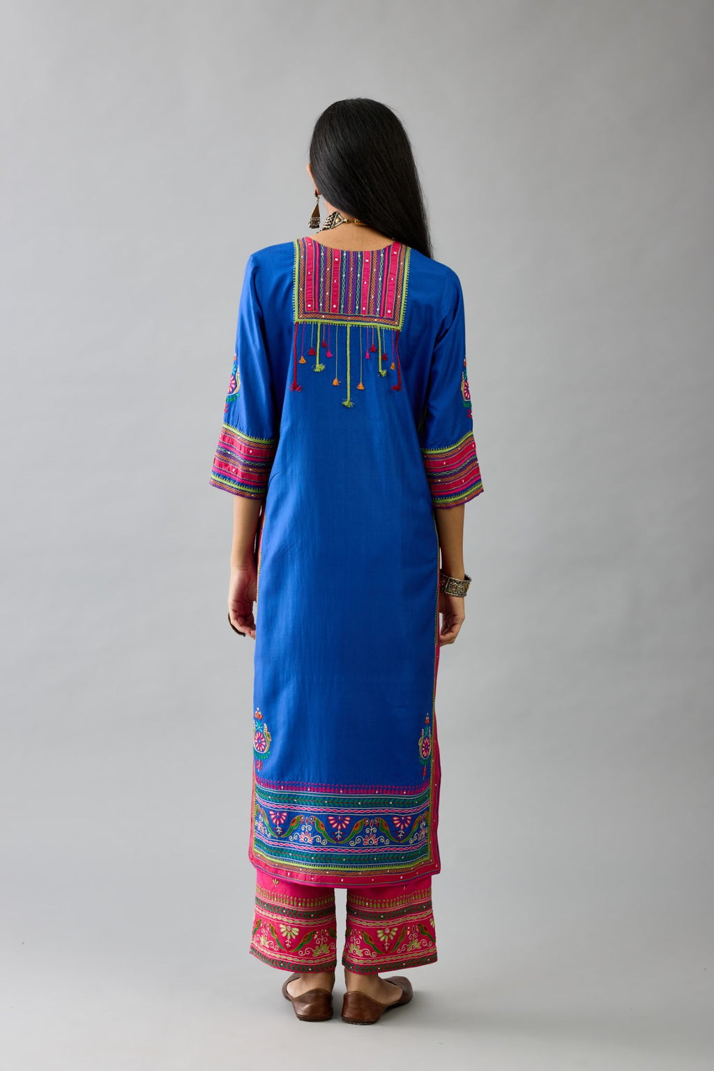 Blue silk straight set kurta with yoke with patchwork and silk thread embroidery highlighted with mirror, sequins, tassels and braids.