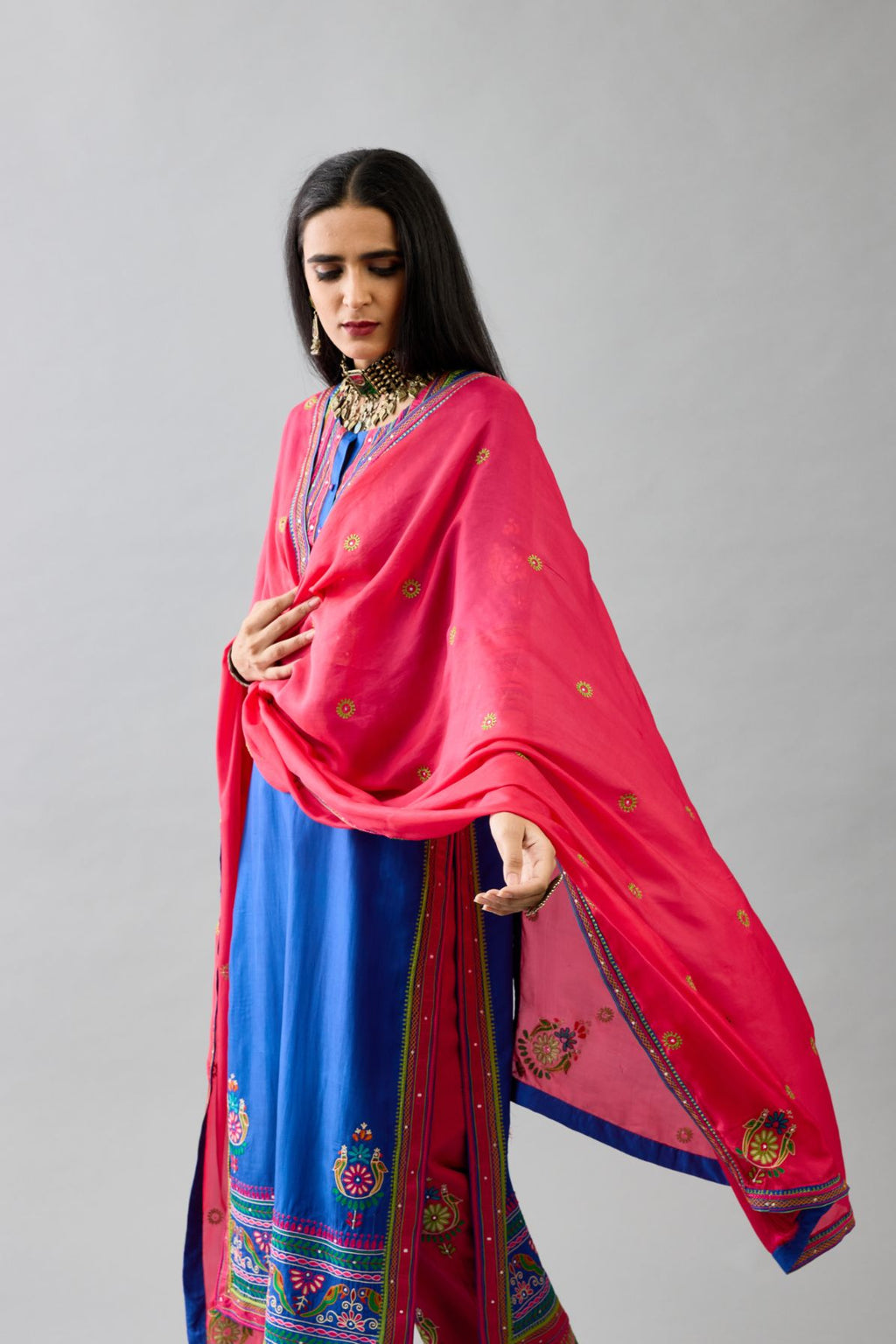 Blue silk straight set kurta with yoke with patchwork and silk thread embroidery highlighted with mirror, sequins, tassels and braids.