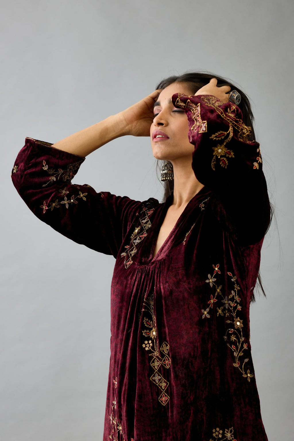 Maroon silk velvet hand block printed easy fit dress with, highlighted with beads, sequins and zari work, paired with green light silk narrow stole with bugle beads fringes.