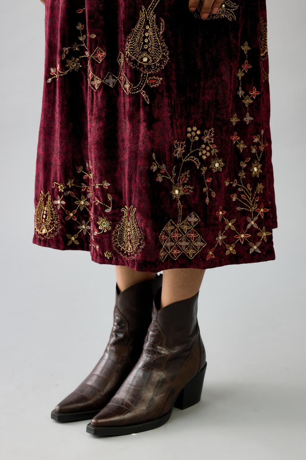 Maroon silk velvet hand block printed easy fit dress with, highlighted with beads, sequins and zari work, paired with green light silk narrow stole with bugle beads fringes.