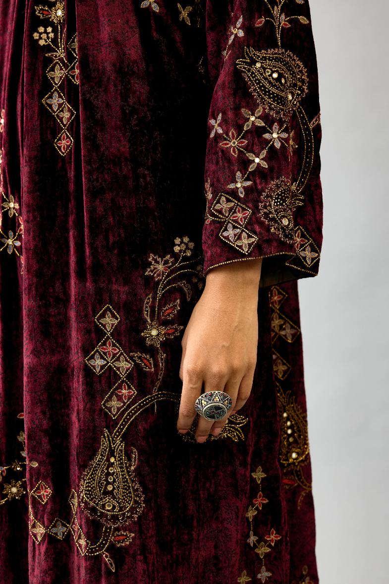Maroon silk velvet hand block printed easy fit dress with, highlighted with beads, sequins and zari work, paired with green light silk narrow stole with bugle beads fringes.