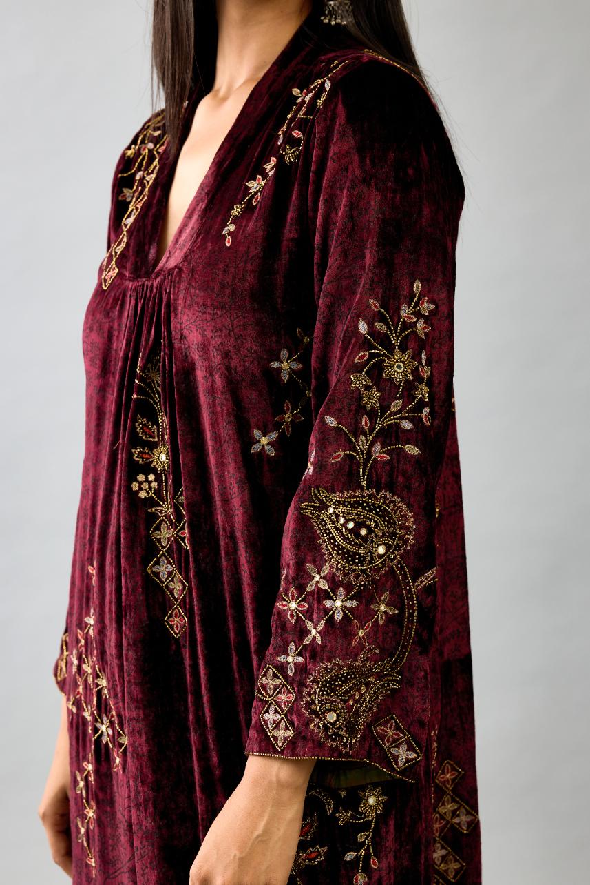 Maroon silk velvet hand block printed easy fit dress with, highlighted with beads, sequins and zari work, paired with green light silk narrow stole with bugle beads fringes.