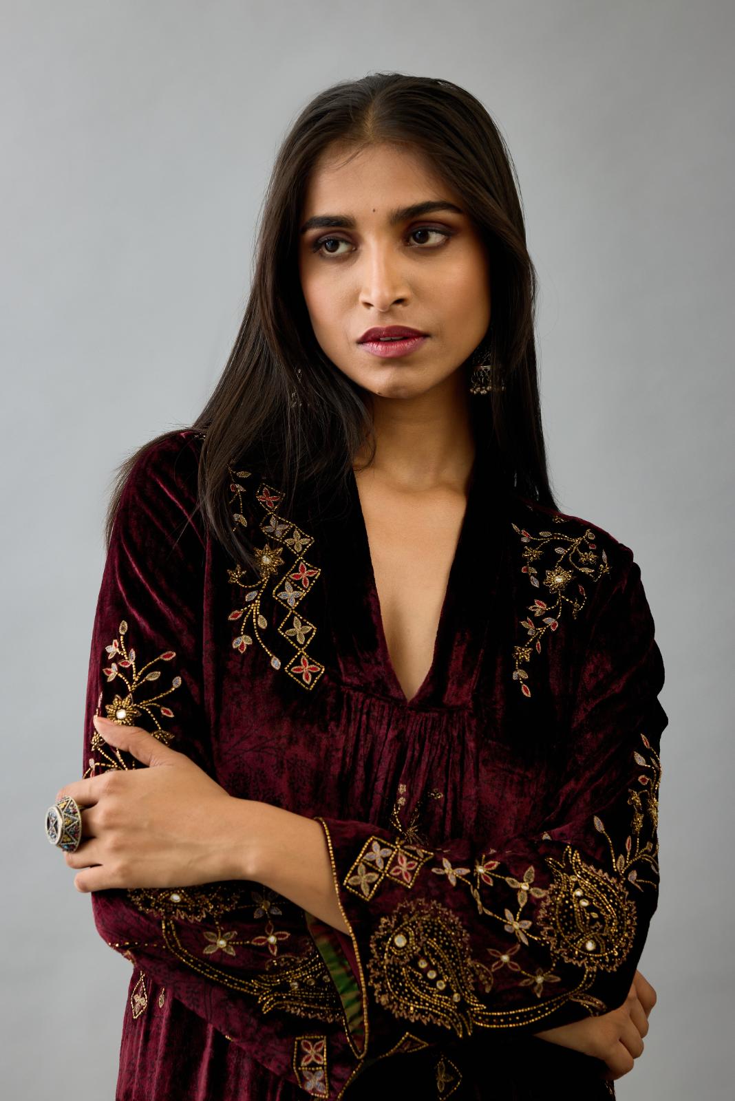 Maroon silk velvet hand block printed easy fit dress with, highlighted with beads, sequins and zari work, paired with green light silk narrow stole with bugle beads fringes.
