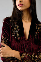 Maroon silk velvet hand block printed easy fit dress with, highlighted with beads, sequins and zari work, paired with green light silk narrow stole with bugle beads fringes.