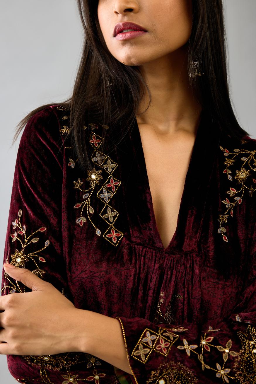 Maroon silk velvet hand block printed easy fit dress with, highlighted with beads, sequins and zari work, paired with green light silk narrow stole with bugle beads fringes.