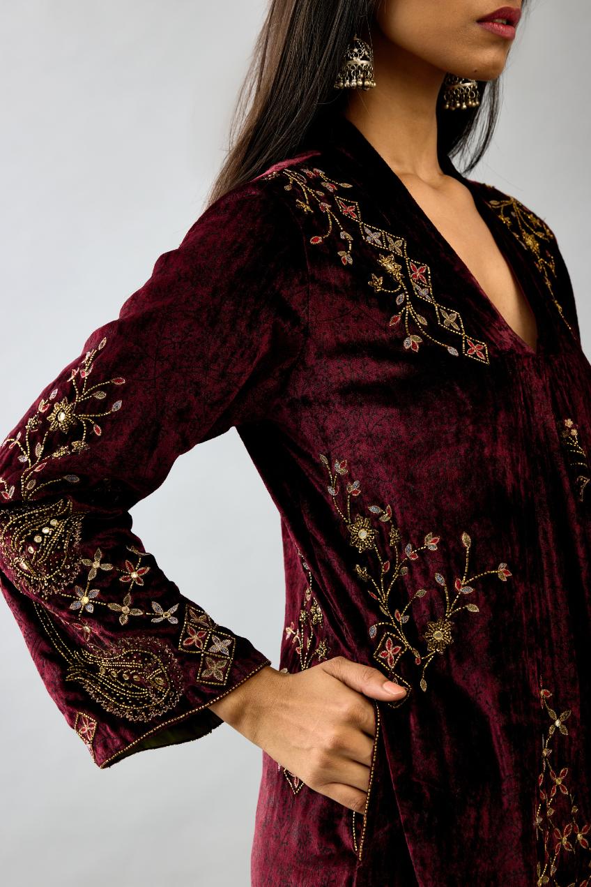 Maroon silk velvet hand block printed easy fit dress with, highlighted with beads, sequins and zari work, paired with green light silk narrow stole with bugle beads fringes.