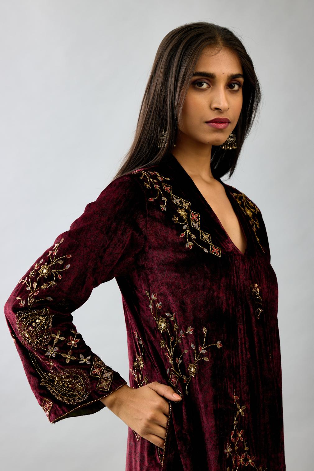 Maroon silk velvet hand block printed easy fit dress with, highlighted with beads, sequins and zari work, paired with green light silk narrow stole with bugle beads fringes.