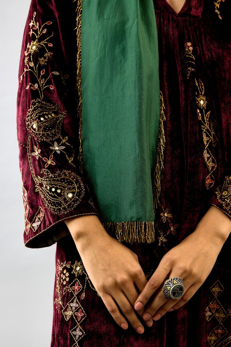 Maroon silk velvet hand block printed easy fit dress with, highlighted with beads, sequins and zari work, paired with green light silk narrow stole with bugle beads fringes.