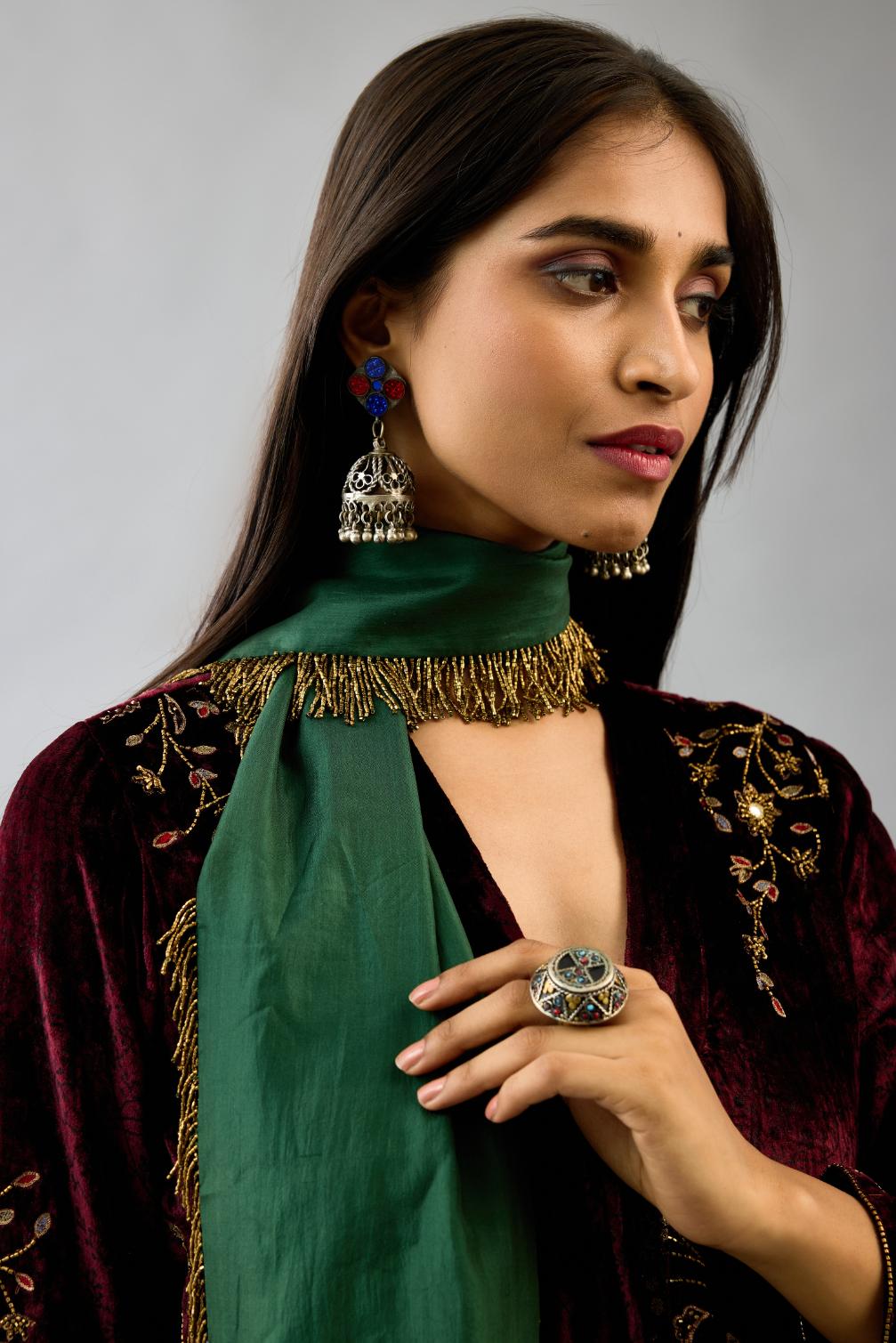 Maroon silk velvet hand block printed easy fit dress with, highlighted with beads, sequins and zari work, paired with green light silk narrow stole with bugle beads fringes.