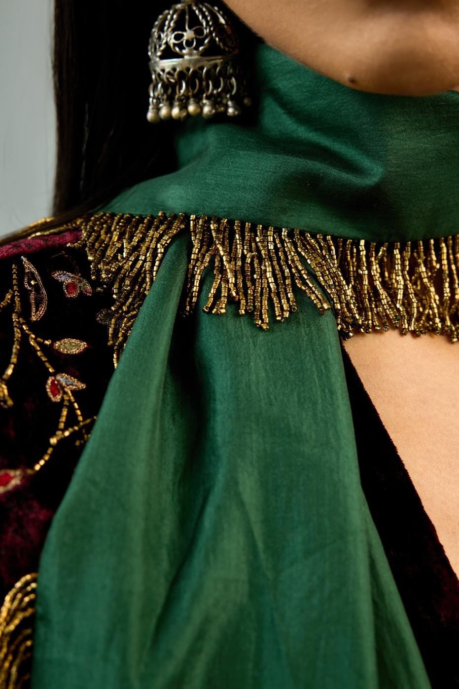 Maroon silk velvet hand block printed easy fit dress with, highlighted with beads, sequins and zari work, paired with green light silk narrow stole with bugle beads fringes.