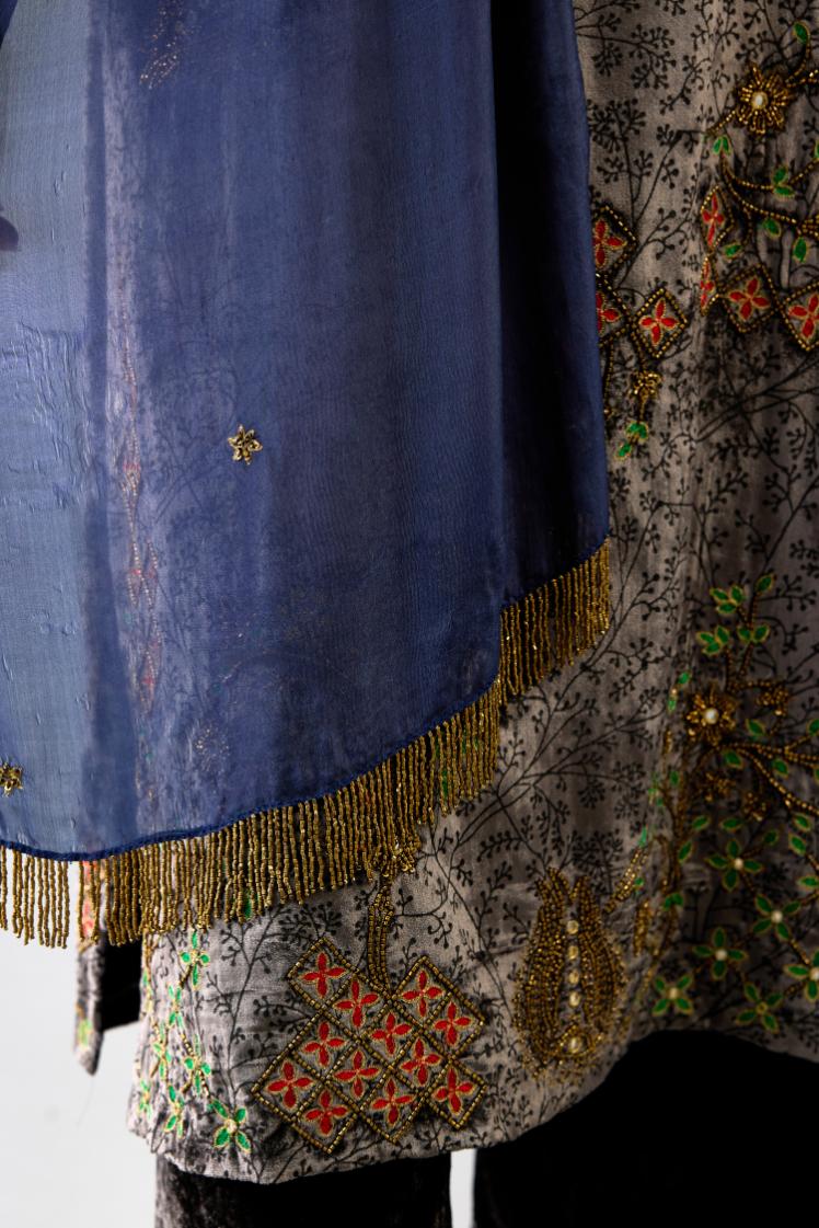 Blue light silk stole with all-over small embroidered booti and fringes at sides.