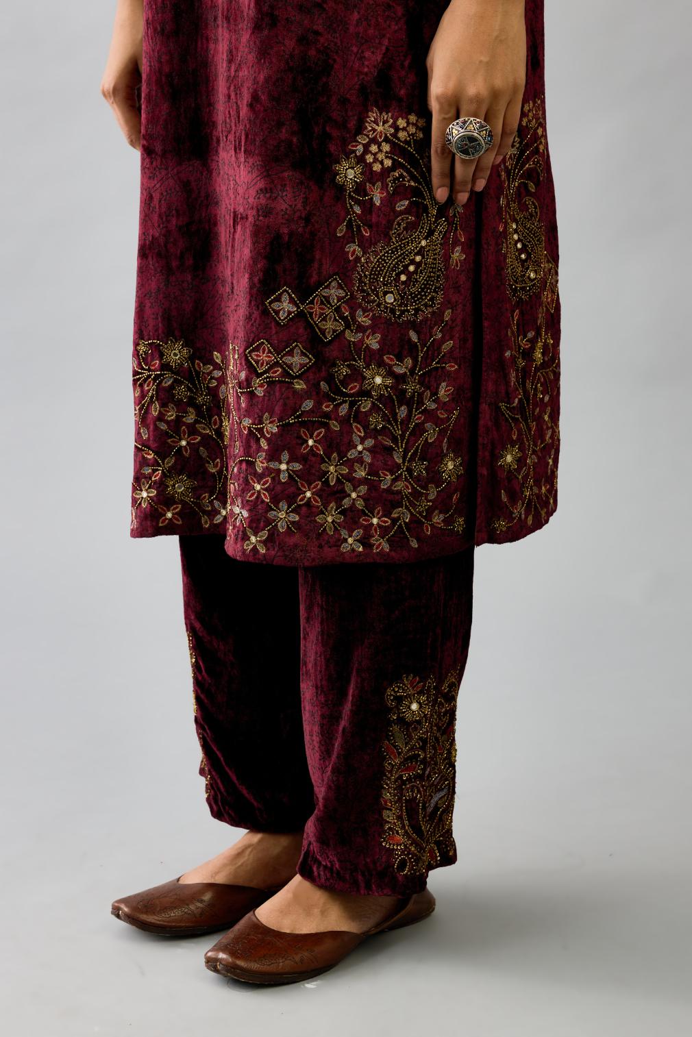 Maroon silk velvet straight mid length kurta with all-over hand block print, highlighted with beads, sequins and zari work at neck & hem.