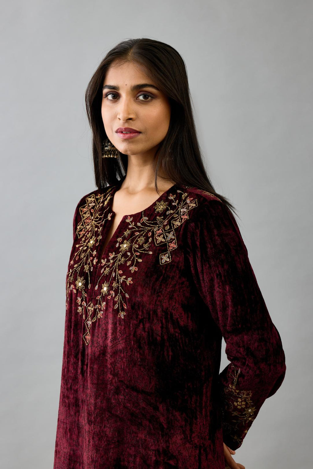 Maroon silk velvet straight mid length kurta with all-over hand block print, highlighted with beads, sequins and zari work at neck & hem.