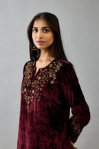 Maroon silk velvet straight mid length kurta with all-over hand block print, highlighted with beads, sequins and zari work at neck & hem.