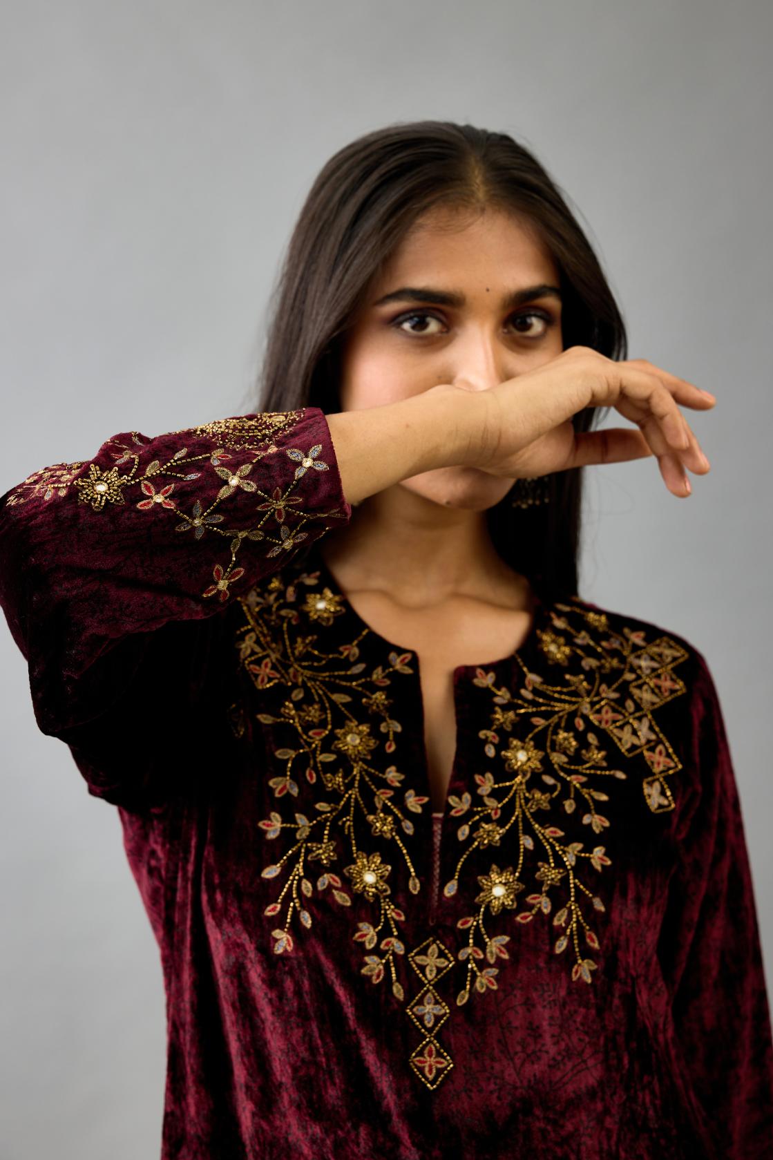 Maroon silk velvet straight mid length kurta with all-over hand block print, highlighted with beads, sequins and zari work at neck & hem.
