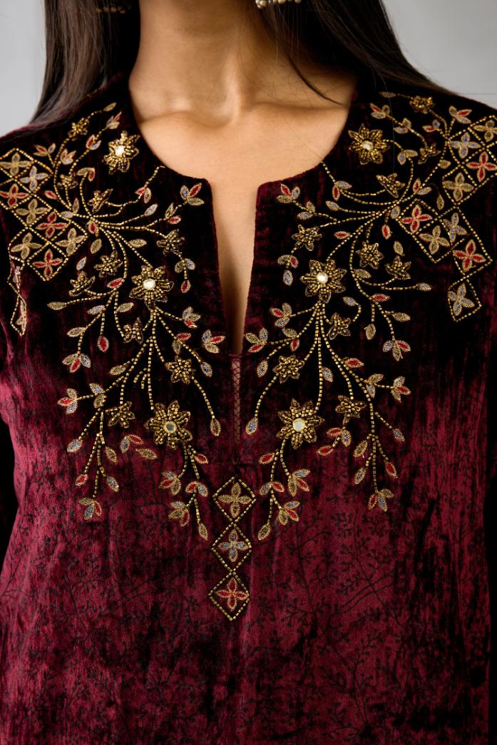 Maroon silk velvet straight mid length kurta with all-over hand block print, highlighted with beads, sequins and zari work at neck & hem.