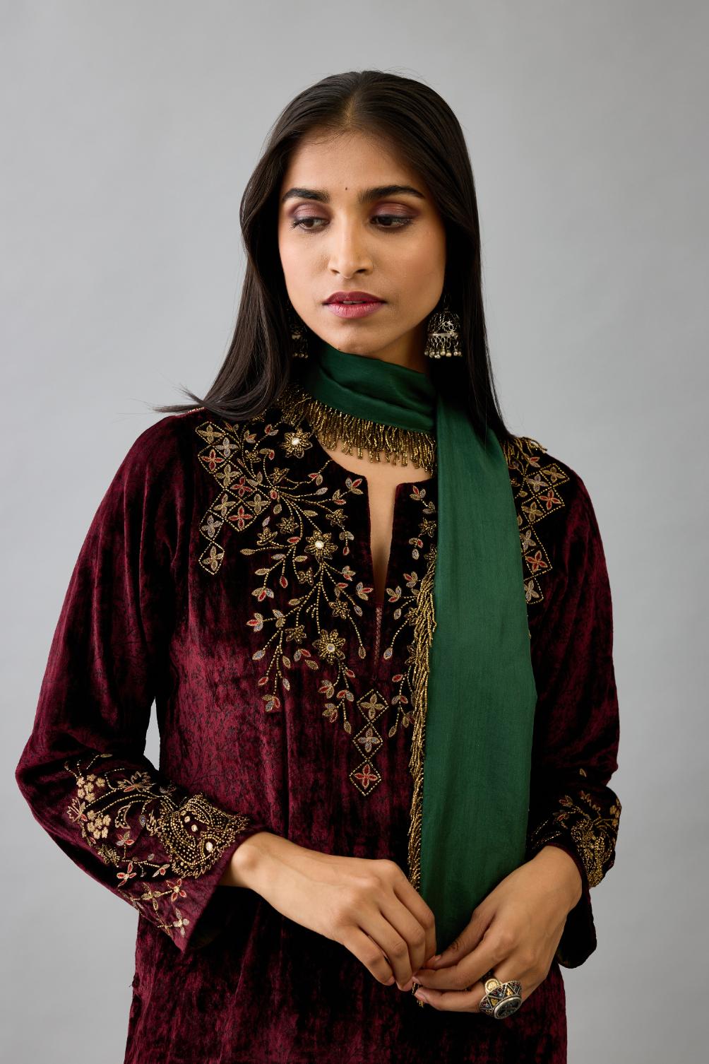 Maroon silk velvet straight mid length kurta with all-over hand block print, highlighted with beads, sequins and zari work at neck & hem.
