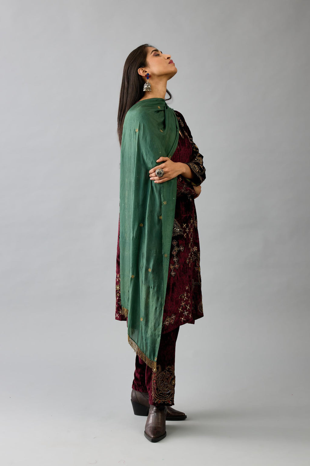 Green light silk stole with all-over small embroidered booti and fringes at sides.