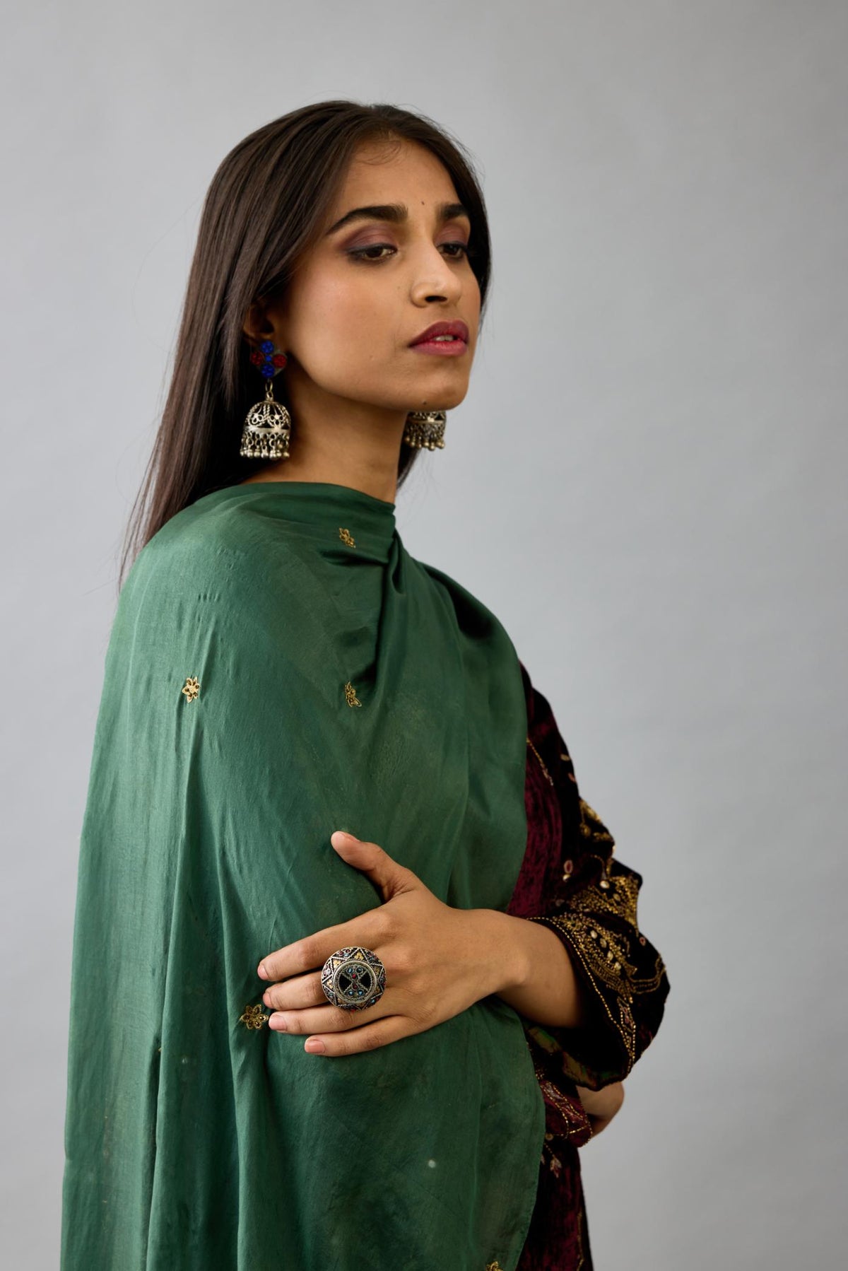 Green light silk stole with all-over small embroidered booti and fringes at sides.