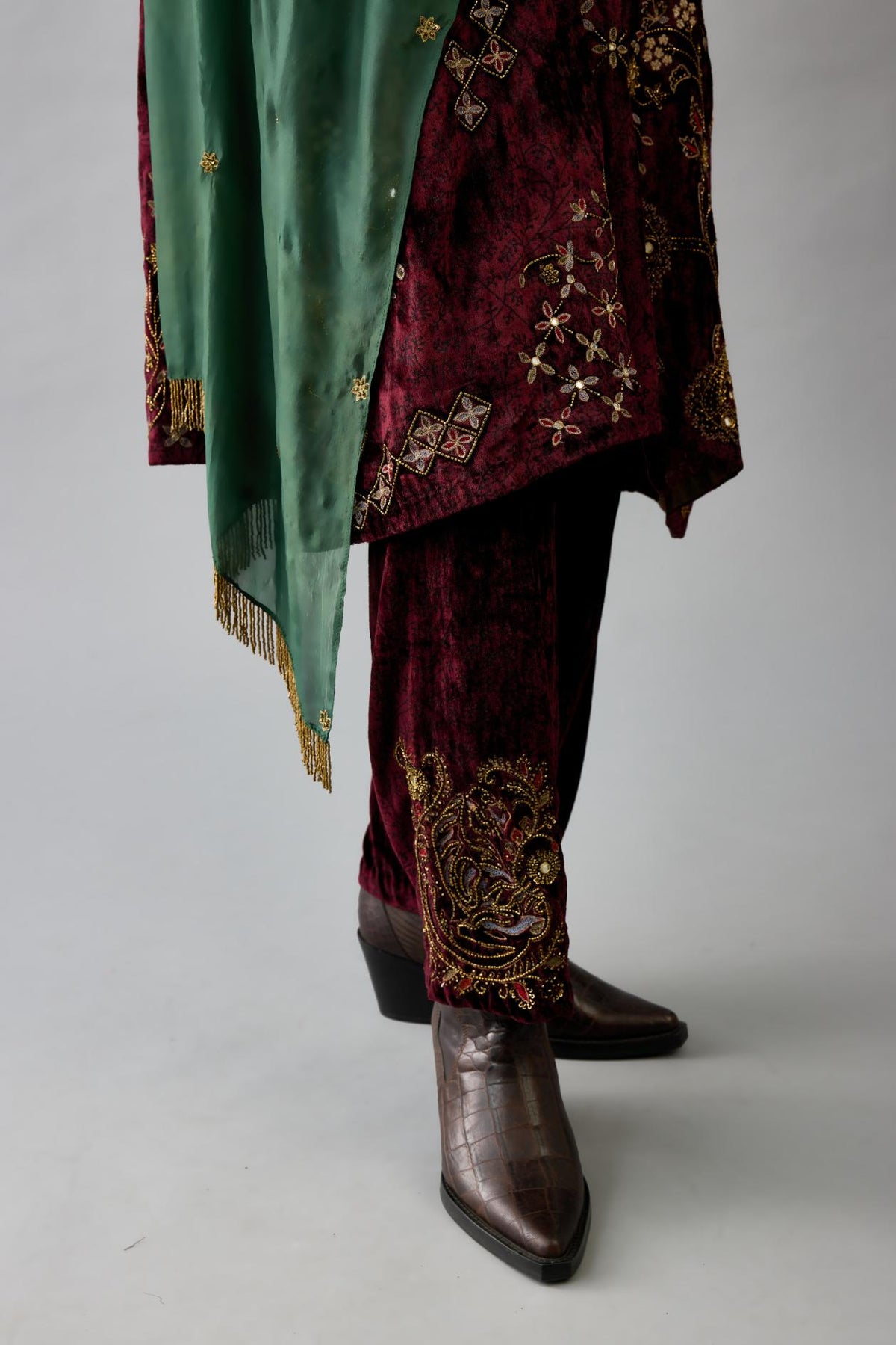 Green light silk stole with all-over small embroidered booti and fringes at sides.