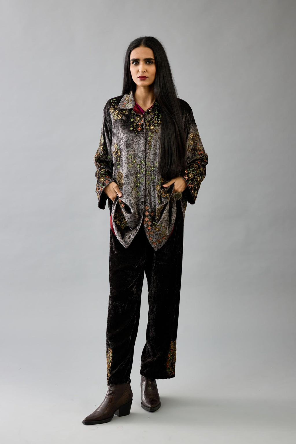 Grey silk velvet shirt with all-over hand block print, highlighted with sequins, beads and zari work, paired with grey silk velvet hand block printed straight pants with embroidered boota at sides, highlighted with sequins, beads and zari work.