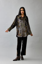 Grey silk velvet shirt with all-over hand block print, highlighted with sequins, beads and zari work, paired with grey silk velvet hand block printed straight pants with embroidered boota at sides, highlighted with sequins, beads and zari work.