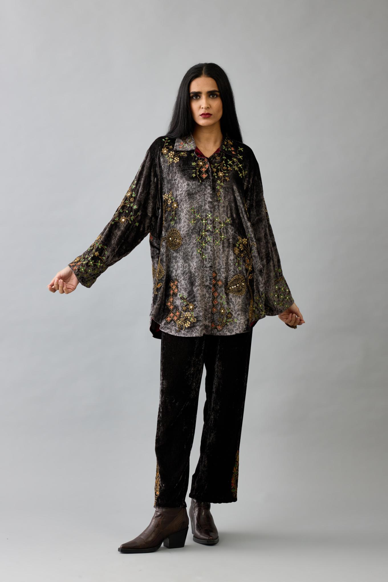 Grey silk velvet shirt with all-over hand block print, highlighted with sequins, beads and zari work, paired with grey silk velvet hand block printed straight pants with embroidered boota at sides, highlighted with sequins, beads and zari work.