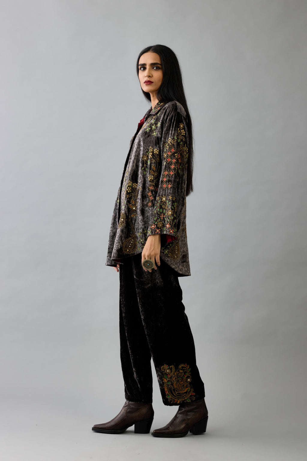 Grey silk velvet shirt with all-over hand block print, highlighted with sequins, beads and zari work, paired with grey silk velvet hand block printed straight pants with embroidered boota at sides, highlighted with sequins, beads and zari work.