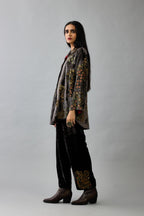Grey silk velvet shirt with all-over hand block print, highlighted with sequins, beads and zari work, paired with grey silk velvet hand block printed straight pants with embroidered boota at sides, highlighted with sequins, beads and zari work.