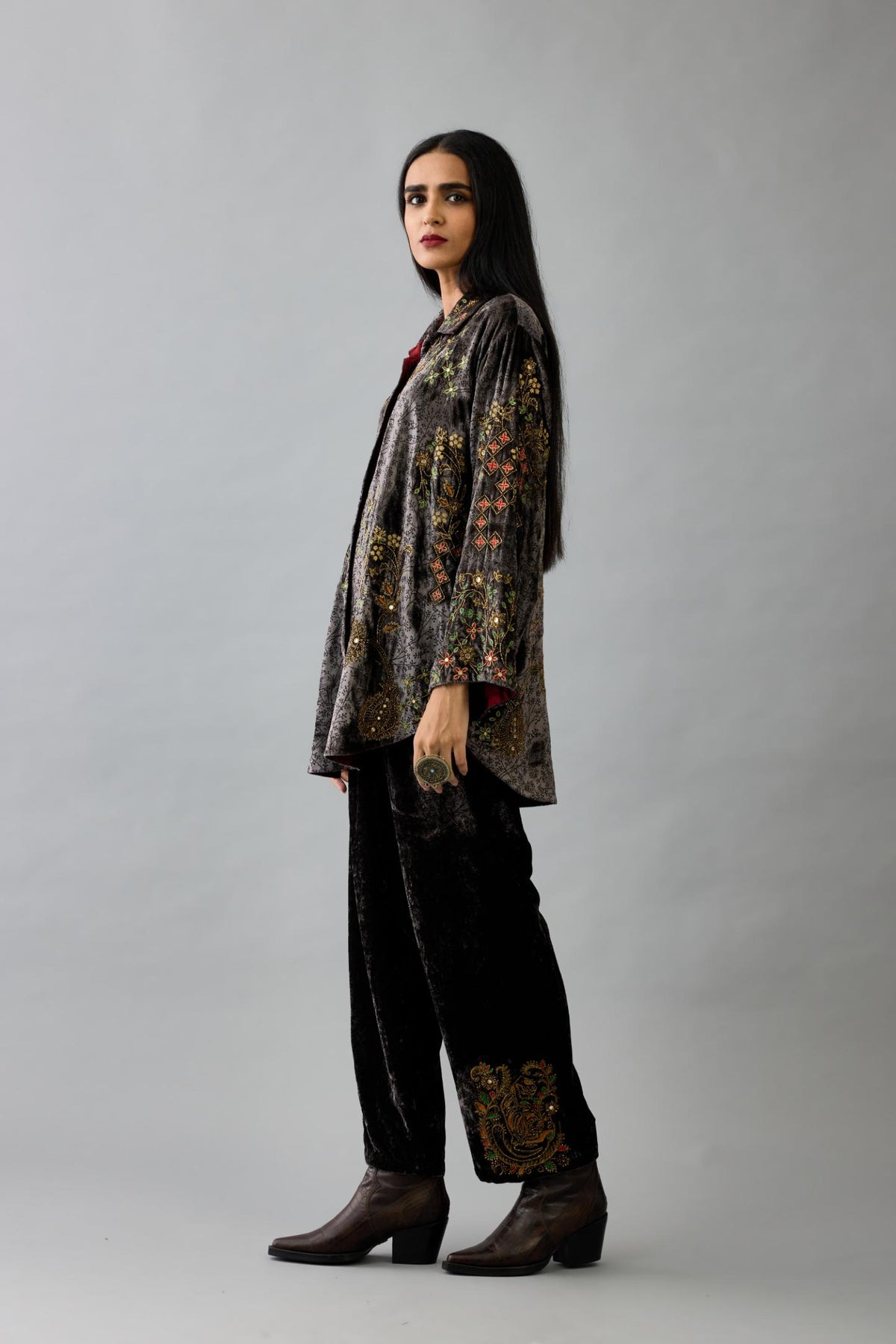 Grey silk velvet shirt with all-over hand block print, highlighted with sequins, beads and zari work, paired with grey silk velvet hand block printed straight pants with embroidered boota at sides, highlighted with sequins, beads and zari work.