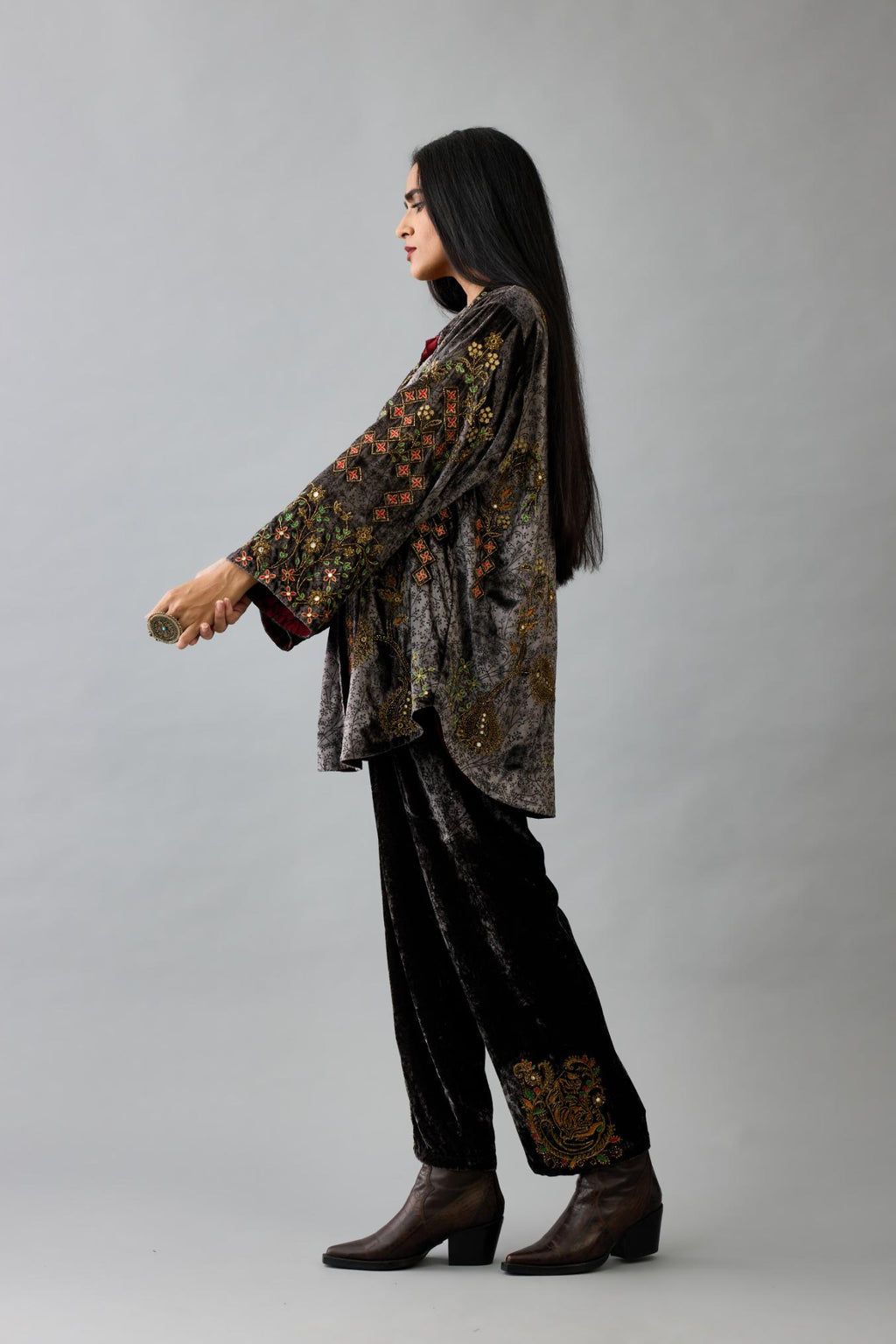 Grey silk velvet shirt with all-over hand block print, highlighted with sequins, beads and zari work, paired with grey silk velvet hand block printed straight pants with embroidered boota at sides, highlighted with sequins, beads and zari work.