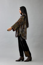 Grey silk velvet shirt with all-over hand block print, highlighted with sequins, beads and zari work, paired with grey silk velvet hand block printed straight pants with embroidered boota at sides, highlighted with sequins, beads and zari work.