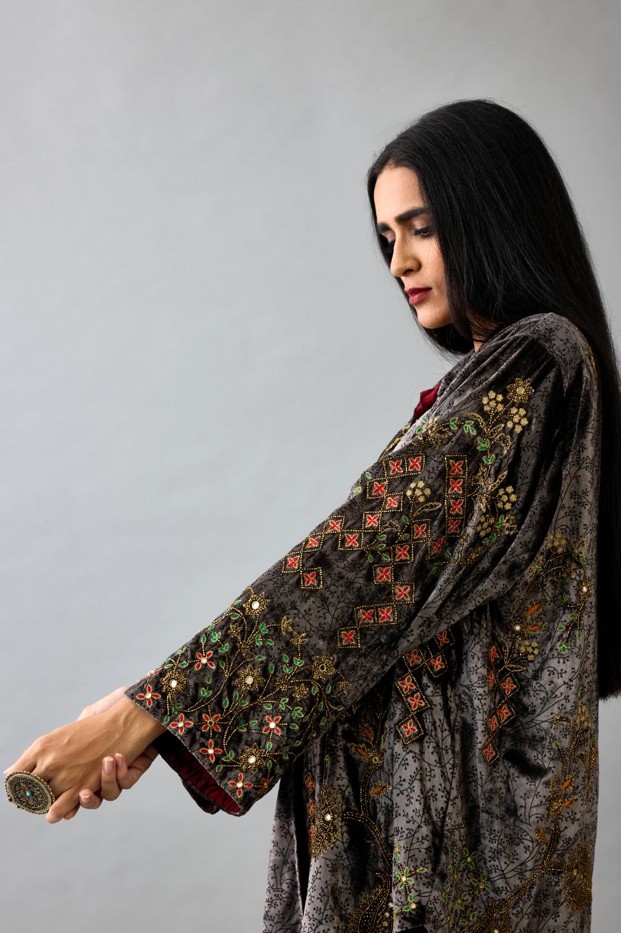 Grey silk velvet shirt with all-over hand block print, highlighted with sequins, beads and zari work, paired with grey silk velvet hand block printed straight pants with embroidered boota at sides, highlighted with sequins, beads and zari work.