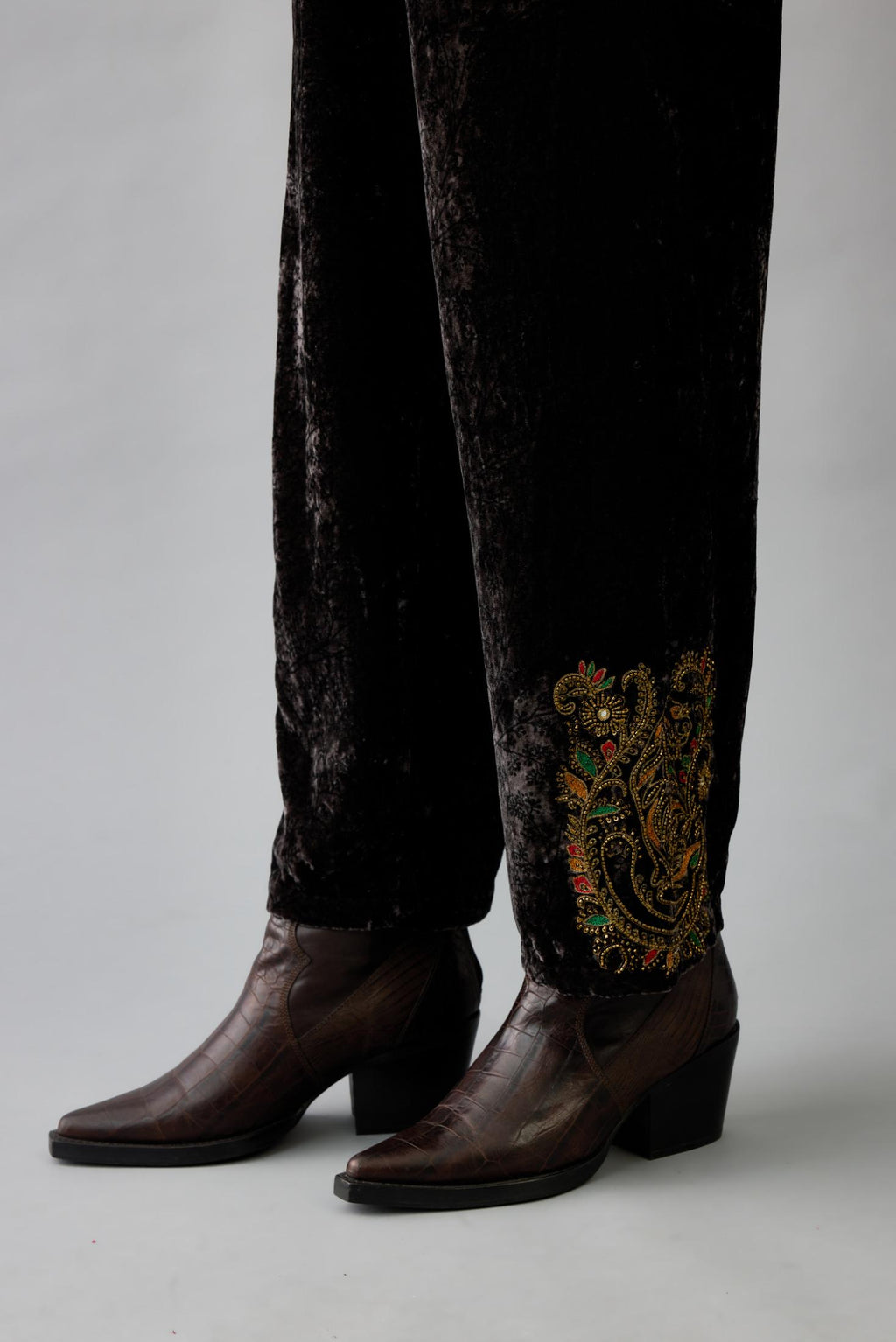 Grey silk velvet hand block printed straight pants with embroidered boota at sides, highlighted with sequins, beads and zari work.