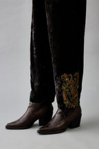 Grey silk velvet hand block printed straight pants with embroidered boota at sides, highlighted with sequins, beads and zari work.