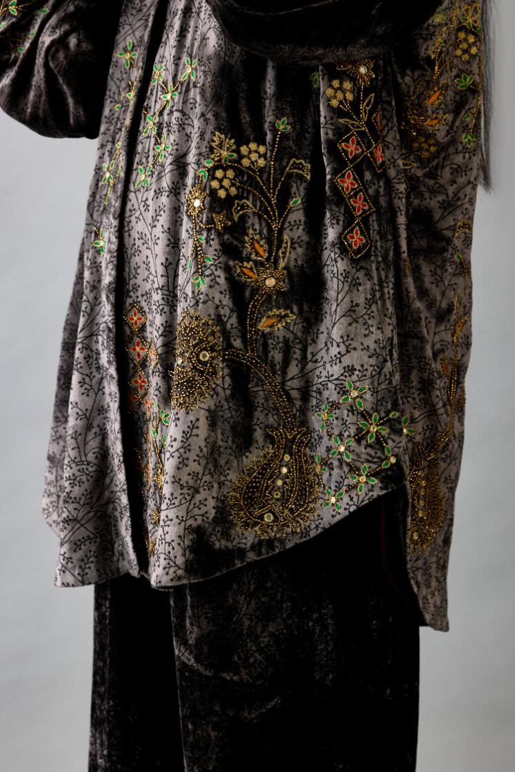 Grey silk velvet shirt with all-over hand block print, highlighted with sequins, beads and zari work, paired with grey silk velvet hand block printed straight pants with embroidered boota at sides, highlighted with sequins, beads and zari work.