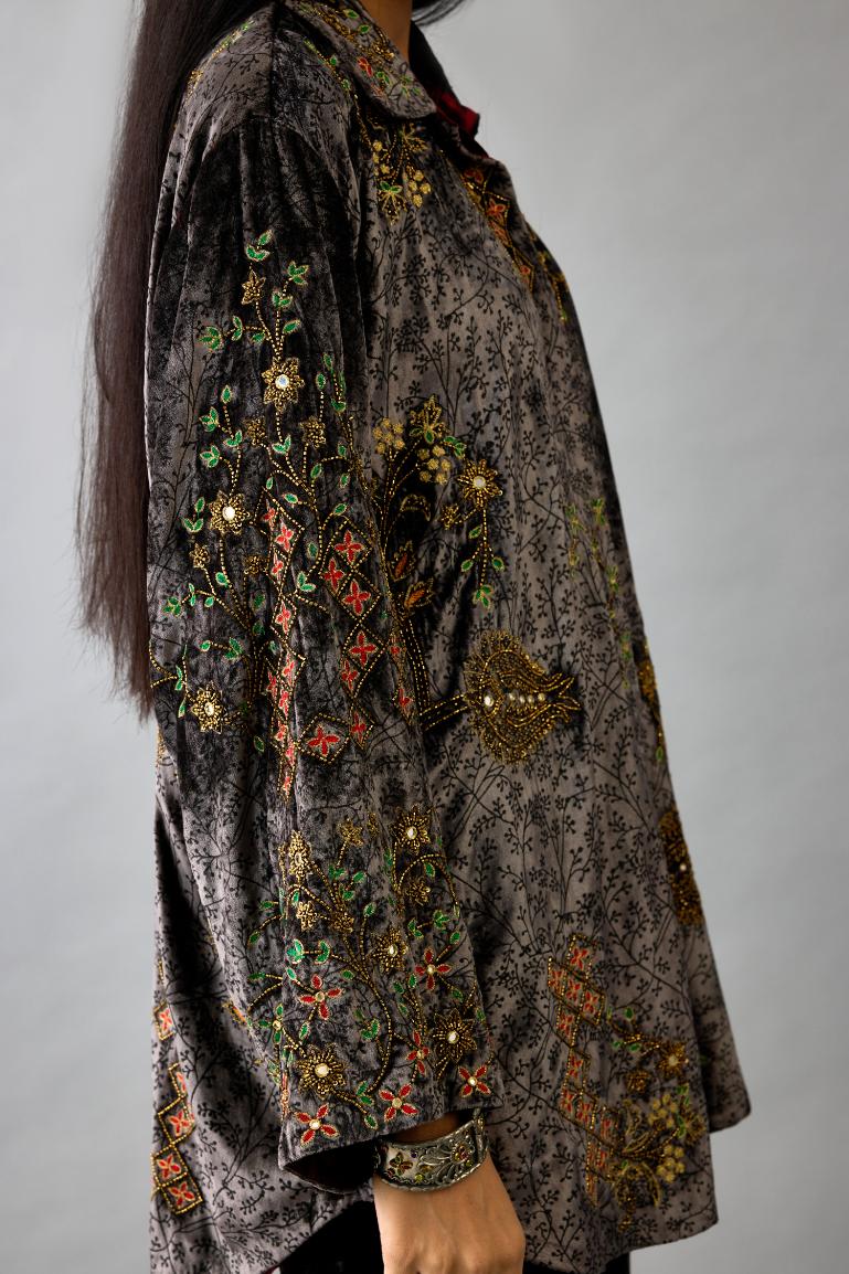 Grey silk velvet shirt with all-over hand block print, highlighted with sequins, beads and zari work, paired with grey silk velvet hand block printed straight pants with embroidered boota at sides, highlighted with sequins, beads and zari work.