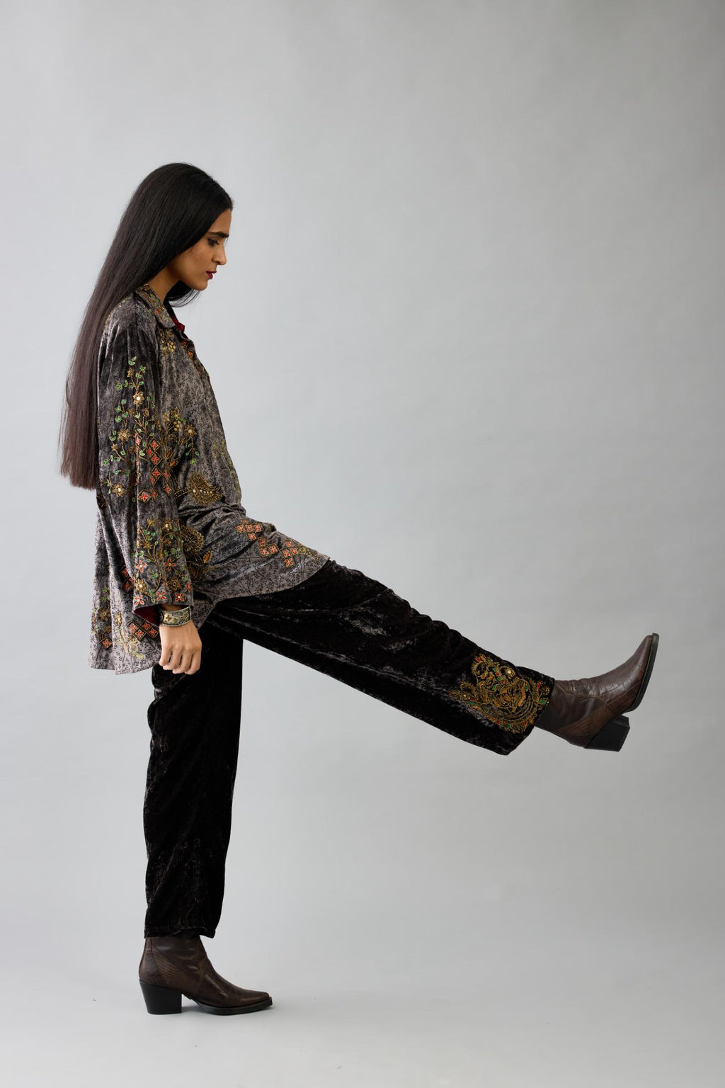 Grey silk velvet shirt with all-over hand block print, highlighted with sequins, beads and zari work, paired with grey silk velvet hand block printed straight pants with embroidered boota at sides, highlighted with sequins, beads and zari work.