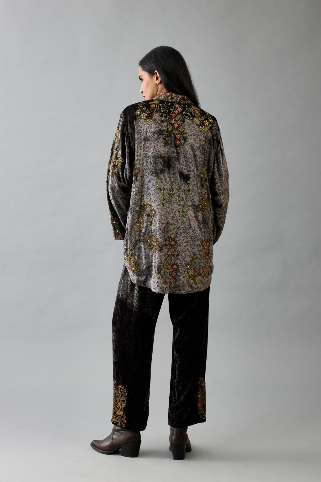 Grey silk velvet shirt with all-over hand block print, highlighted with sequins, beads and zari work, paired with grey silk velvet hand block printed straight pants with embroidered boota at sides, highlighted with sequins, beads and zari work.