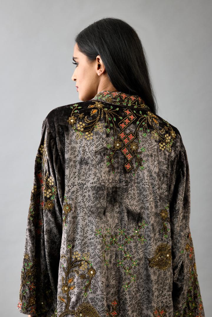 Grey silk velvet shirt with all-over hand block print, highlighted with sequins, beads and zari work, paired with grey silk velvet hand block printed straight pants with embroidered boota at sides, highlighted with sequins, beads and zari work.