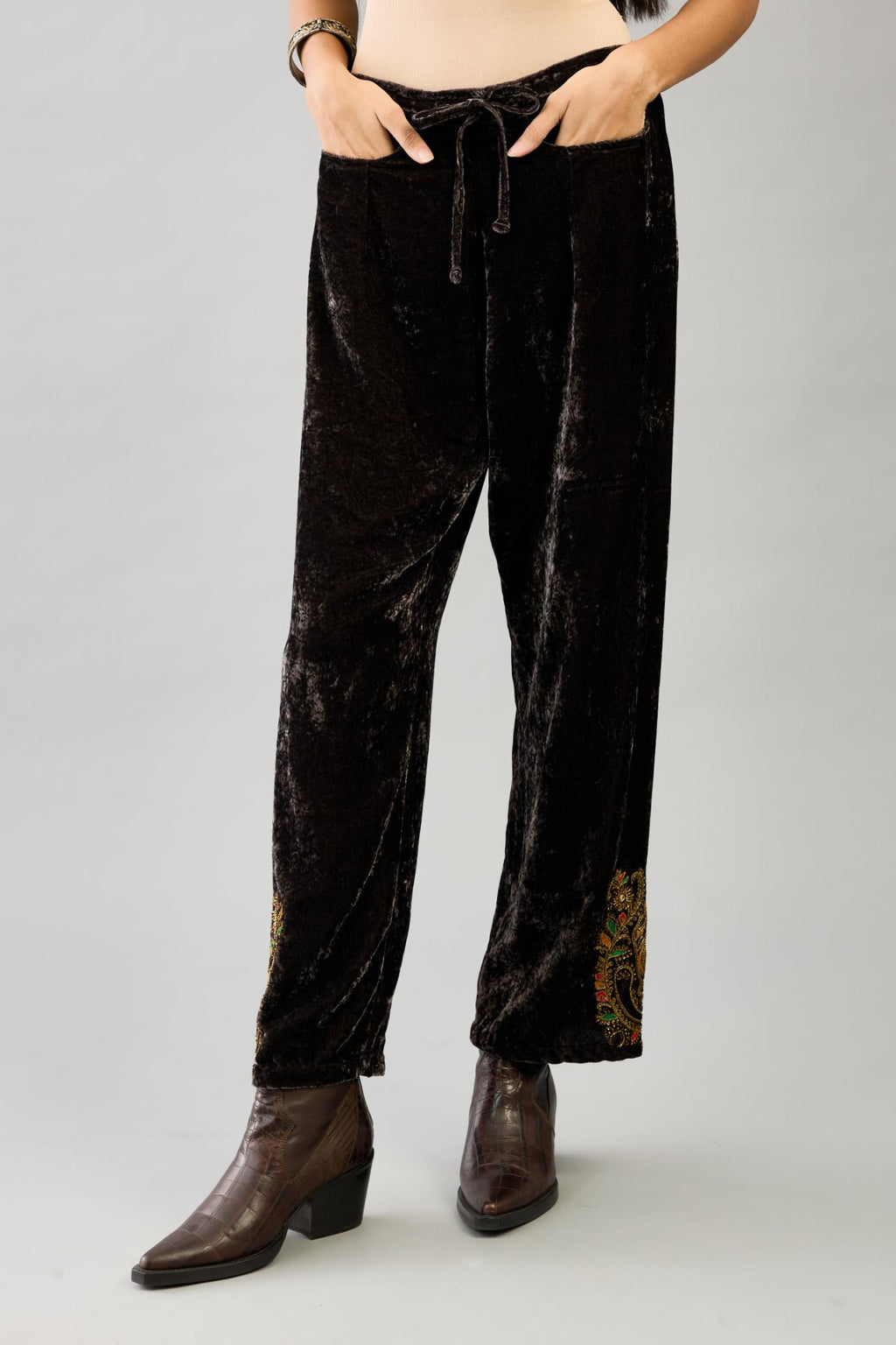 Grey silk velvet hand block printed straight pants with embroidered boota at sides, highlighted with sequins, beads and zari work.