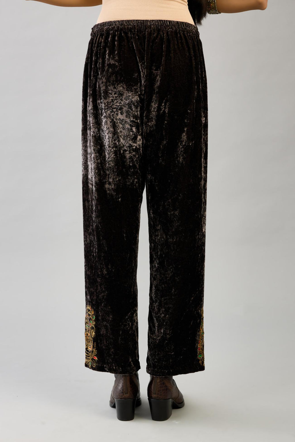 Grey silk velvet hand block printed straight pants with embroidered boota at sides, highlighted with sequins, beads and zari work.